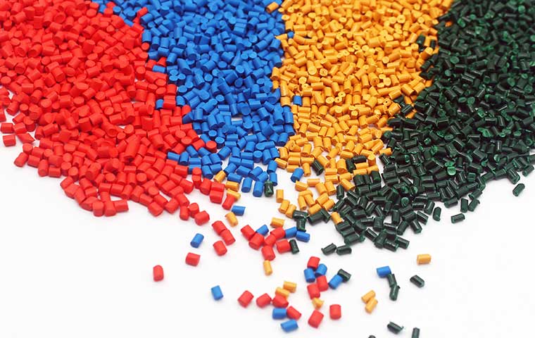 Masterbatch pellets in various colors, used for coloring and enhancing properties in plastic manufacturing processes